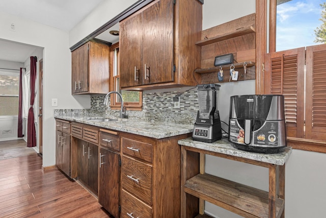4405 6th St NE, Columbia Heights, MN 55421 - kitchen with open shelves, backsplash, wood finished floors, and healthy amount of natural light