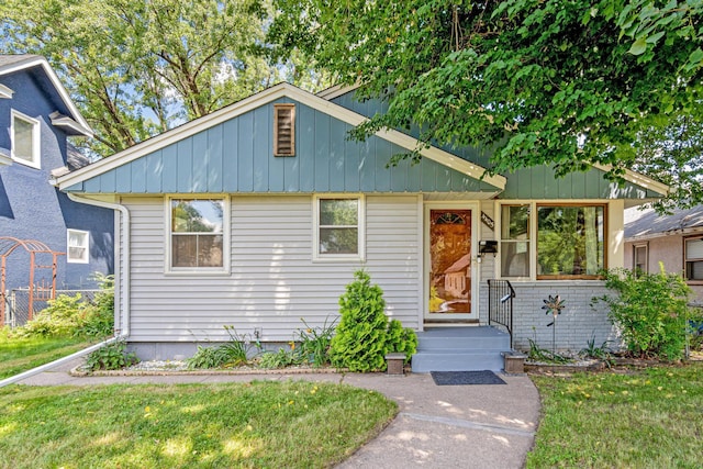 4405 6th St NE, Columbia Heights, MN 55421 - bungalow-style home featuring a front yard and board and batten siding