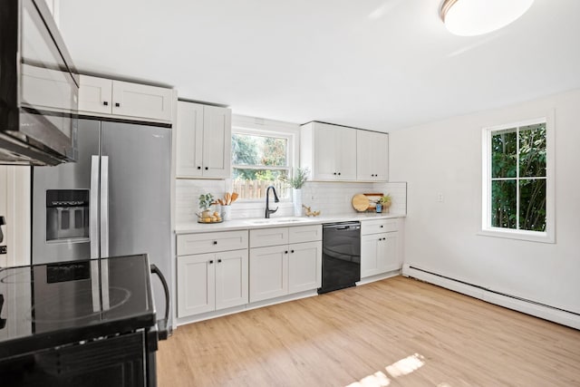 26030 2nd St W, Zimmerman, MN 55398 - kitchen with black appliances, light countertops, decorative backsplash, and light wood finished floors