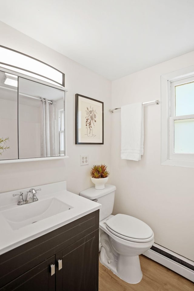 26030 2nd St W, Zimmerman, MN 55398 - bathroom featuring a baseboard heating unit, vanity, wood finished floors, and a shower with curtain