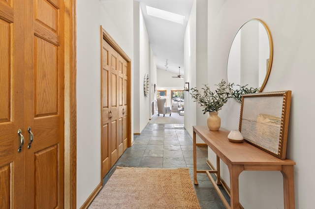 1701 Baywood Ln, Mound, MN 55364 - hall featuring stone tile floors, lofted ceiling, and a skylight
