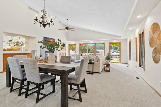 1701 Baywood Ln, Mound, MN 55364 - dining room featuring lofted ceiling, light carpet, a ceiling fan, a chandelier, and a textured ceiling