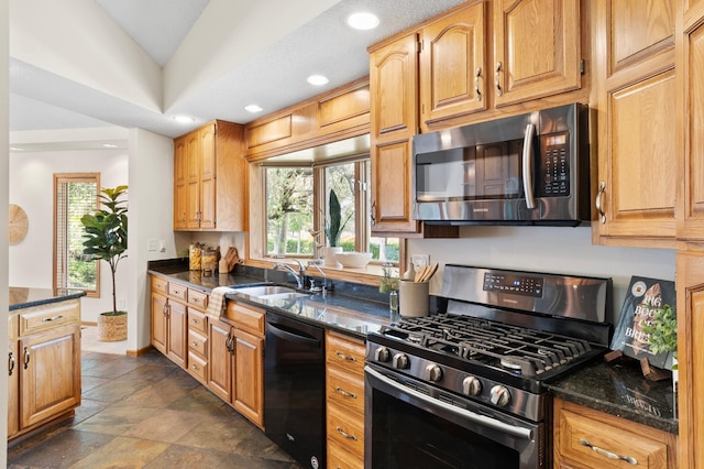 1701 Baywood Ln, Mound, MN 55364 - kitchen with stainless steel appliances, plenty of natural light, dark stone counters, lofted ceiling, and recessed lighting