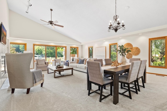 1701 Baywood Ln, Mound, MN 55364 - dining area featuring high vaulted ceiling, light colored carpet, a chandelier, and a ceiling fan