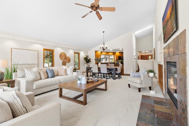 1701 Baywood Ln, Mound, MN 55364 - living room featuring a tiled fireplace, carpet floors, a chandelier, ceiling fan, and high vaulted ceiling