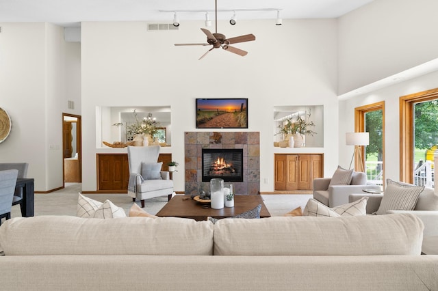 1701 Baywood Ln, Mound, MN 55364 - living room featuring a towering ceiling, a tiled fireplace, track lighting, a ceiling fan, and built in features