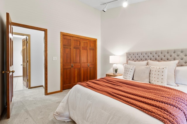 1701 Baywood Ln, Mound, MN 55364 - bedroom featuring rail lighting, a towering ceiling, light colored carpet, and a closet