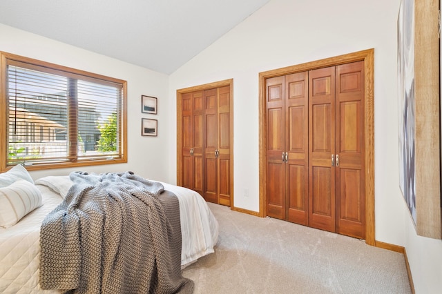 1701 Baywood Ln, Mound, MN 55364 - bedroom featuring multiple closets, light carpet, and vaulted ceiling