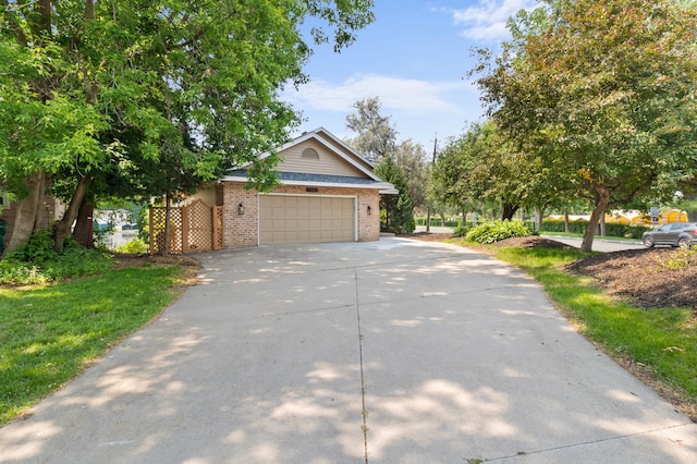 1701 Baywood Ln, Mound, MN 55364 - view of front facade with driveway, brick siding, and an attached garage