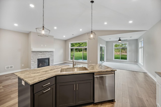 4786 384th St, North Branch, MN 55056 - kitchen featuring stainless steel dishwasher, open floor plan, a stone fireplace, plenty of natural light, and vaulted ceiling
