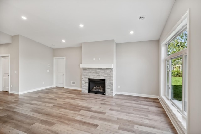 4786 384th St, North Branch, MN 55056 - unfurnished living room featuring light wood-style floors, recessed lighting, and a stone fireplace
