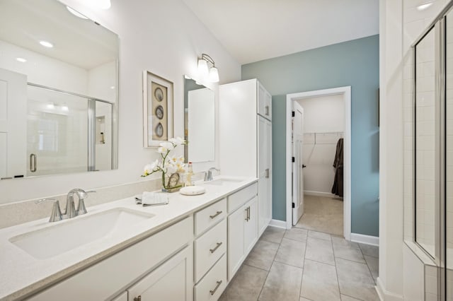 6501 Tamarack Ln, Corcoran, MN 55340 - full bathroom featuring a stall shower, double vanity, a spacious closet, and tile patterned floors