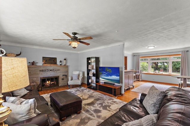 1682 Oakdale Ave W, Saint Paul, MN 55118 - living area with light wood finished floors, a brick fireplace, a ceiling fan, and a textured ceiling