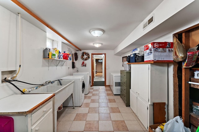 1682 Oakdale Ave W, Saint Paul, MN 55118 - laundry room with washer and clothes dryer, light tile patterned flooring, and cabinet space