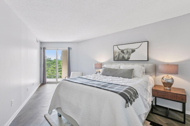 1200 Nicollet Mall Unit 523, Minneapolis, MN 55403 - bedroom featuring a textured ceiling, wood finished floors, and access to exterior