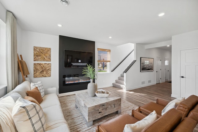 10663 Hemingway Ave S, Cottage Grove, MN 55016 - living area featuring stairway, recessed lighting, wood finished floors, and a fireplace