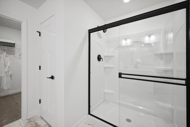 10663 Hemingway Ave S, Cottage Grove, MN 55016 - bathroom with a stall shower, a spacious closet, and marble finish flooring