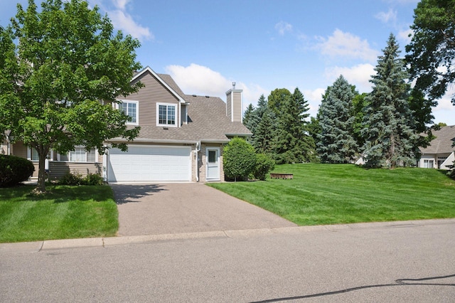18347 Coneflower Ln, Eden Prairie, MN 55346 - view of front of home with asphalt driveway, a chimney, a front yard, and a garage