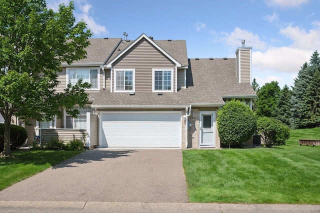 18347 Coneflower Ln, Eden Prairie, MN 55346 - traditional-style house featuring driveway, an attached garage, roof with shingles, a chimney, and a front lawn