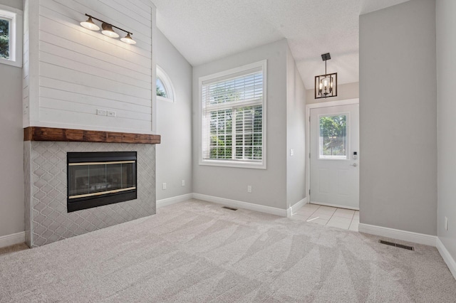18347 Coneflower Ln, Eden Prairie, MN 55346 - unfurnished living room featuring carpet, a chandelier, a tiled fireplace, and vaulted ceiling
