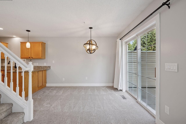 18347 Coneflower Ln, Eden Prairie, MN 55346 - kitchen featuring light colored carpet, a textured ceiling, pendant lighting, a chandelier, and recessed lighting