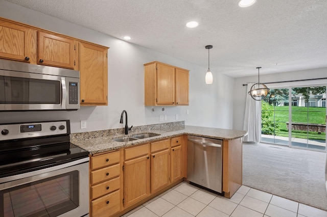 18347 Coneflower Ln, Eden Prairie, MN 55346 - kitchen featuring stainless steel appliances, light carpet, a peninsula, a textured ceiling, and light stone counters