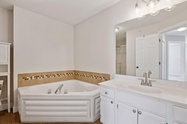 18347 Coneflower Ln, Eden Prairie, MN 55346 - full bathroom featuring vanity, a bath, a stall shower, and wood finished floors
