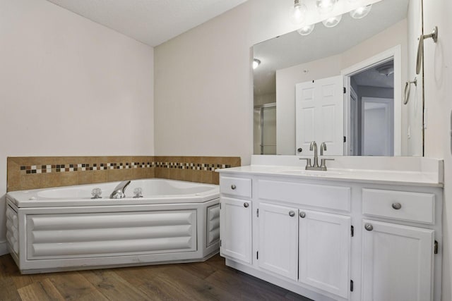 18347 Coneflower Ln, Eden Prairie, MN 55346 - full bath featuring vanity, a stall shower, a bath, and wood finished floors