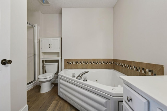 18347 Coneflower Ln, Eden Prairie, MN 55346 - bathroom featuring wood finished floors, a stall shower, a whirlpool tub, and a textured ceiling