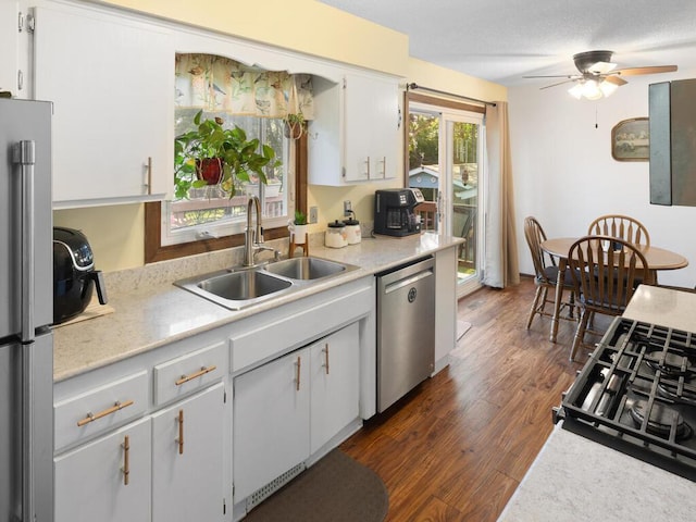 1507 234th Ln NE, Bethel, MN 55005 - kitchen with appliances with stainless steel finishes, light countertops, a ceiling fan, and dark wood-style flooring