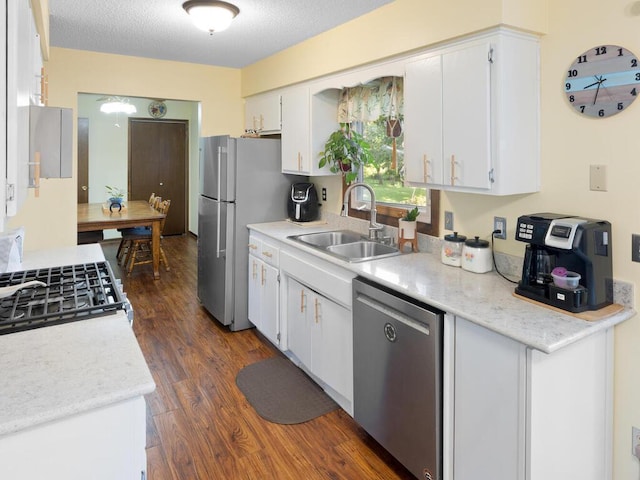 1507 234th Ln NE, Bethel, MN 55005 - kitchen with stainless steel appliances, dark wood finished floors, light countertops, white cabinets, and a textured ceiling