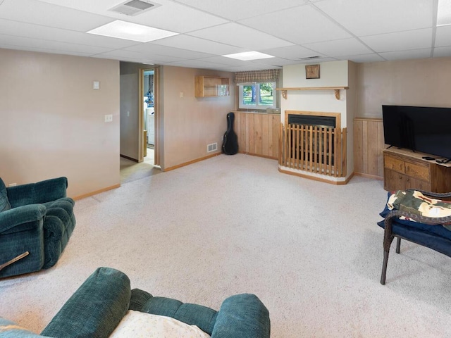 1507 234th Ln NE, Bethel, MN 55005 - living area with a drop ceiling, a fireplace, carpet floors, and wood walls