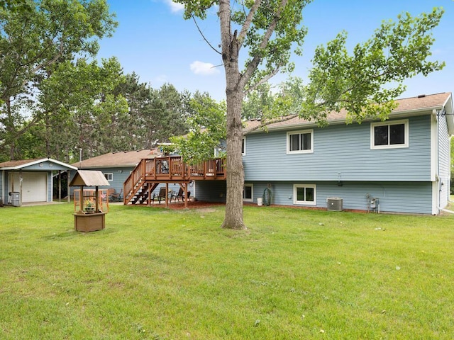 1507 234th Ln NE, Bethel, MN 55005 - rear view of house featuring a lawn, stairs, a deck, an outbuilding, and a garage