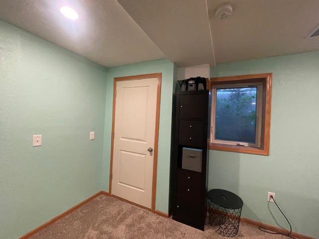 1141 5th St E, Saint Paul, MN 55106 - unfurnished bedroom with baseboards and carpet flooring