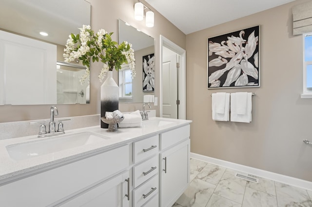 8398 Lander Ave NE, Otsego, MN 55330 - bathroom featuring double vanity and marble look tile flooring