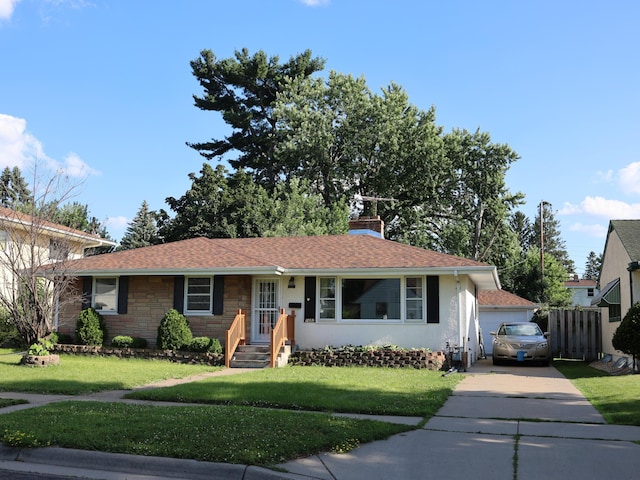 1682 Cottage Ave E, Saint Paul, MN 55106 - view of front facade with a front lawn, a chimney, stone siding, and a detached garage