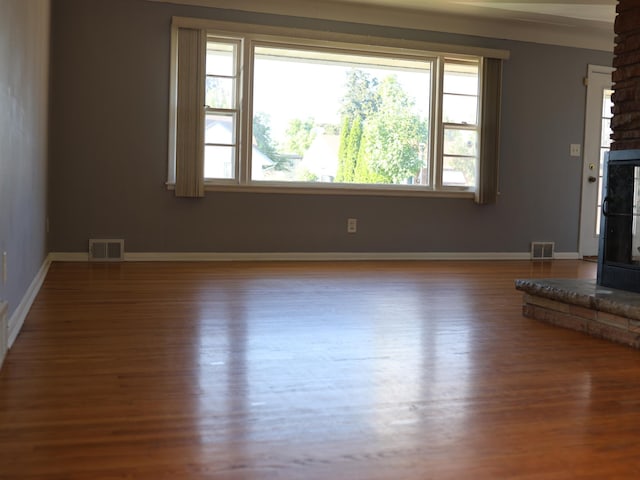 1682 Cottage Ave E, Saint Paul, MN 55106 - unfurnished living room featuring wood finished floors and a fireplace with raised hearth