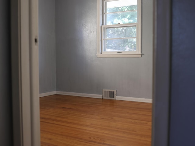 1682 Cottage Ave E, Saint Paul, MN 55106 - unfurnished room featuring wood finished floors and baseboards