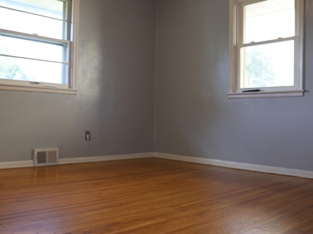 1682 Cottage Ave E, Saint Paul, MN 55106 - empty room with wood finished floors and baseboards