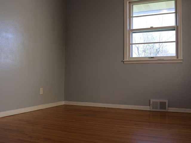 1682 Cottage Ave E, Saint Paul, MN 55106 - unfurnished room featuring wood finished floors and healthy amount of natural light