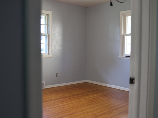1682 Cottage Ave E, Saint Paul, MN 55106 - empty room featuring light wood finished floors and baseboards