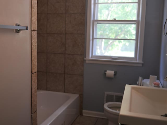 1682 Cottage Ave E, Saint Paul, MN 55106 - full bath featuring tile patterned flooring and  shower combination