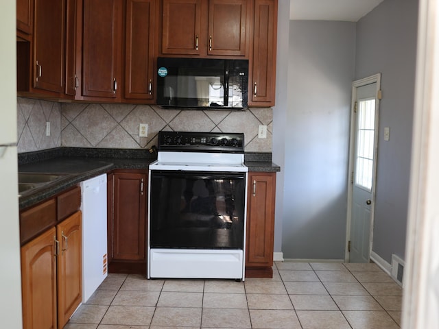 1682 Cottage Ave E, Saint Paul, MN 55106 - kitchen featuring white appliances, dark countertops, backsplash, and light tile patterned flooring