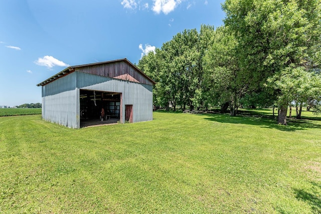 39205 436th St, Saint Peter, MN 56082 - view of grassy yard featuring a detached garage, an outbuilding, and an outdoor structure