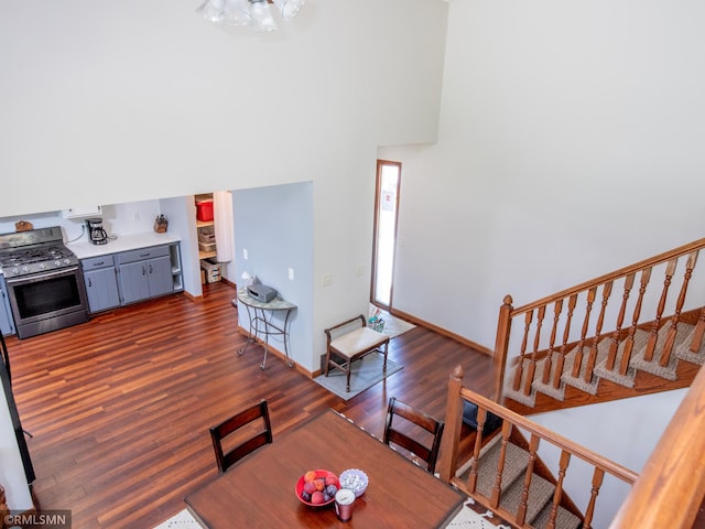 5424 Vernon Ct, Savage, MN 55378 - living room featuring dark wood-style floors, a towering ceiling, and a chandelier