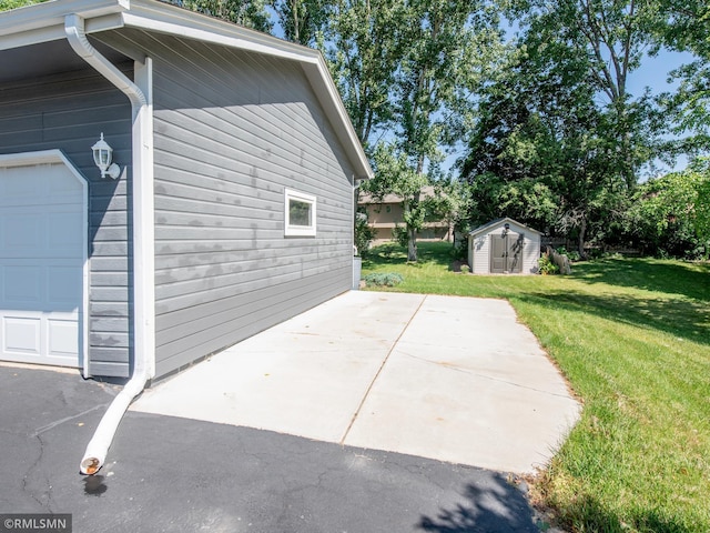 5424 Vernon Ct, Savage, MN 55378 - view of side of property featuring a storage unit, a garage, a lawn, and a patio