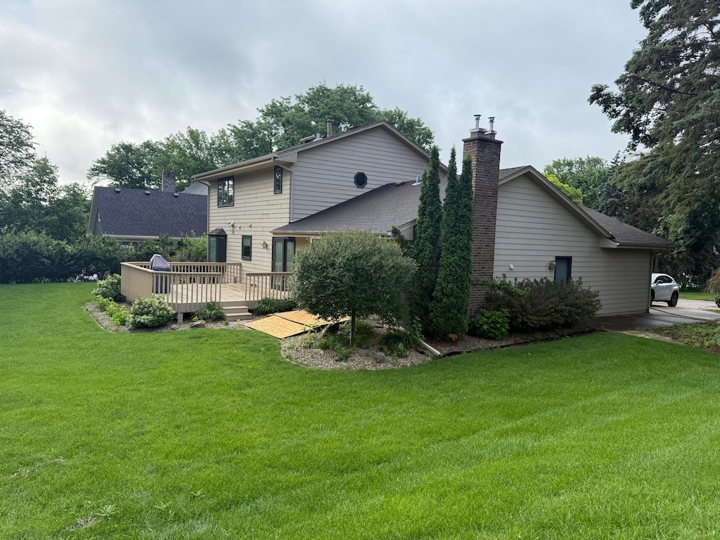 12280 48th Ave N, Plymouth, MN 55442 - back of property featuring a chimney, a deck, and a lawn