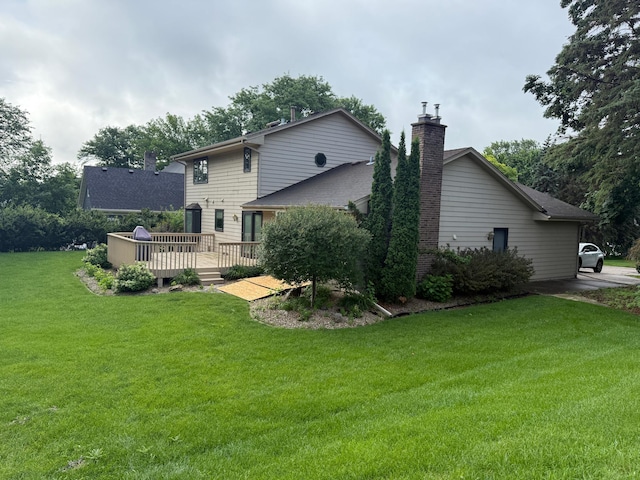 12280 48th Ave N, Plymouth, MN 55442 - back of property featuring a chimney, a deck, and a lawn