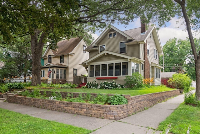 1756 Minnehaha Ave W, Saint Paul, MN 55104 - view of front of property featuring a sunroom, a chimney, and a front yard