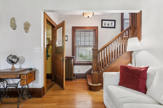 1756 Minnehaha Ave W, Saint Paul, MN 55104 - entrance foyer featuring light wood-style flooring, radiator, ornamental molding, and stairs